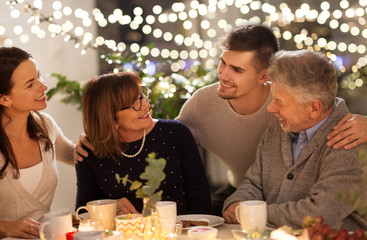 celebration, holidays and people concept - happy family having tea party at home