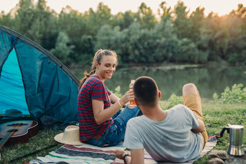 Wall Mural - friends on camping outdoor by the lake or river