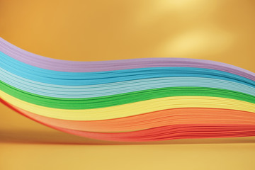 Beautiful rainbow color ribbon on orange background.