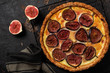 Homemade quiche tart with figs, cream cheese and honey on dark brown background. Vintage style. Top view.