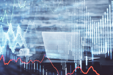 Stock market graph on background with desk and personal computer. Multi exposure. Concept of financial analysis.