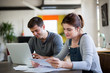© ReeldealHD images - Young adult couple working on finance application together