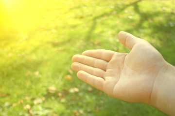 empty man hands begging asking for money, help me, reaching out and compassion concept.helping hand concept and international day of peace on green meadow background.