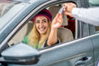 young woman take the key from valet to drive her car