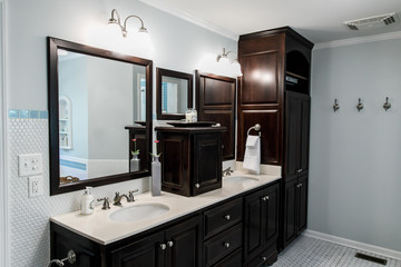 1950's styl1950's style bathroom with tile floor and dark brown cabinets in white and blue ace bathroom with tile floor and dark brown cabinets in white and blue accents wit a window and natural light