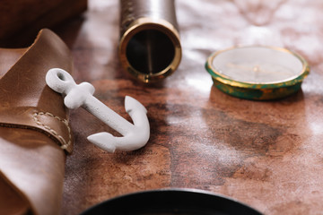 Sticker - close up view of white anchor near compass and telescope on old world map