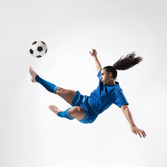 Full shot fit woman kicking ball