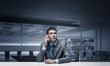 © adam121 - Young man talking on phone and looking at camera