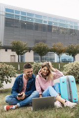 Traveling. Couple Using Phone, Waiting Transport Near Airport