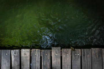 vintage wooden bridge on the water free space for text. Top view of old wood panel bridge background.