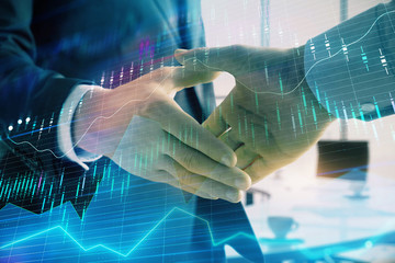 Multi exposure of financial graph on office background with two businessmen handshake. Concept of success in business