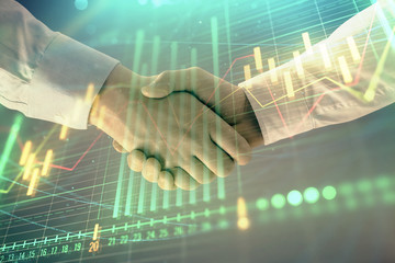 Multi exposure of forex graph on abstract background with two businessmen handshake. Concept of success on stock market