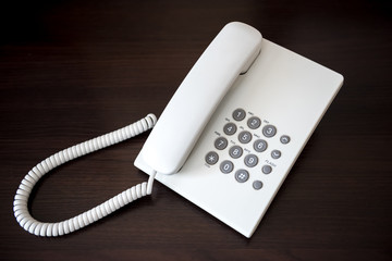 white telephone on wooden background