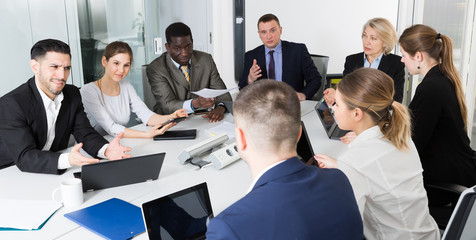 Wall Mural - Multinational team of confident business partners discussing