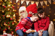 © soleg - The children waited a long time for Santa, now they fell asleep and Santa quietly goes to the Christmas tree to give presents - Merry Christmas and Happy Holidays!