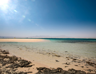 Wall Mural - Summer background of sea with beach and blue sunny sky 