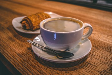 cup of coffee on wooden table