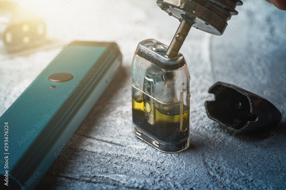 vape pen e-liquid refill Refill with e-juice or liquid with salt nicotine of replacement cartridge  for vape pod or new vape pen device Stock Photo