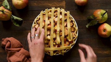 Wall Mural - Lattice apple pie cooking process, timelapse footage. Woman hands preparing food. Top view