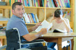 © auremar - mature student in wheelchair in library