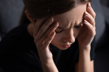 Wall Mural - upset young woman touching face with closed eyes at home