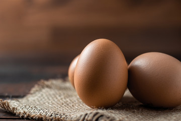 Fresh farm brown eggs over a rustic wood table