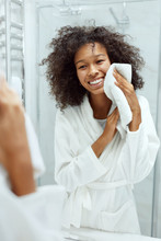 Woman Cleaning Face Skin With White Towel At Bathroom Portrait
