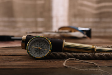 Sticker - compass near telescope and rope cable on brown wooden table