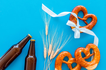 Wall Mural - Beer festival Octoberfest. Pretzels and beer on blue background top view space for text