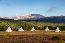Beautiful View Of The Tipi In A Field With American Rocky Mountain Landscape In The Background During A Sunny Summer Morning. Taken In Montana Near Glacier National Park, USA.