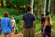 © Valmedia - Diverse people enjoy spiritual gathering A multigenerational group of individuals are seen standing in a circle in a forest clearing as they practice shamanic and native traditions in nature.