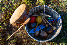 Sacred Drums During Spiritual Singing. A Top Down View Of Sacred And Traditional Native American Musical Instruments, Leather Beaters, Rawhide Drum And Rattles Are Seen From Above.