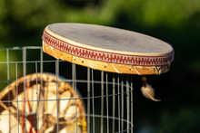 Sacred Drums During Spiritual Singing. A Native American Drum Is Seen Up Close And From The Side, With Traditional Leather Membrane, Wood Frame, And Hand Stitched Edging, With Copy Space.
