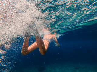  Underwater photo of girl swimming in the sea