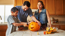 Halloween Activity - Family Carving Pumpkin Into Jack-o-lantern