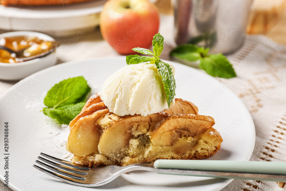 Piece of apple pie with ice cream on plate
