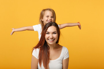 Wall Mural - Woman in light clothes have fun with cute child baby girl 4-5 years old. Mommy little kid daughter isolated on yellow background studio portrait. Mother's Day love family parenthood childhood concept.