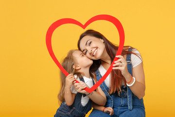 Woman in light clothes have fun with cute child baby girl 4-5 years old. Mommy little kid daughter isolated on yellow background studio portrait. Mother's Day love family parenthood childhood concept.