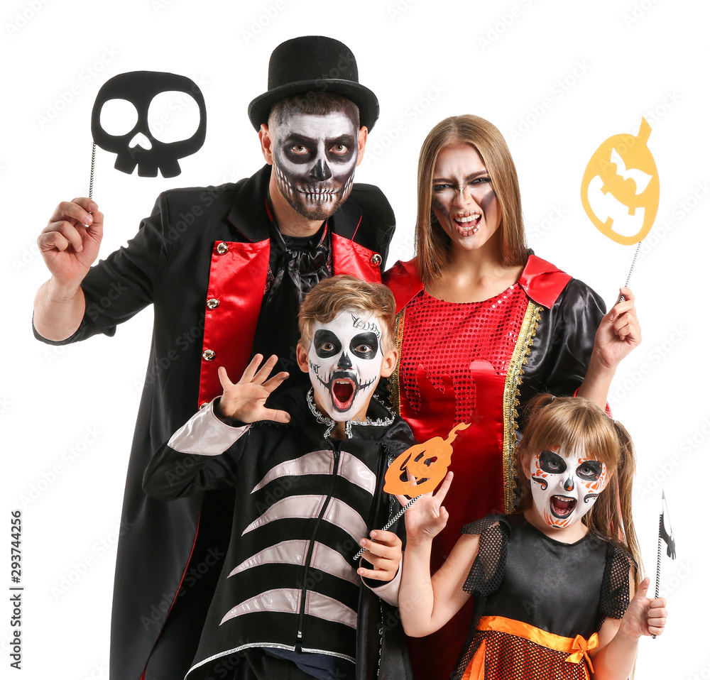 Family in Halloween costumes on white background