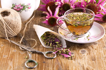 Wall Mural - Tea drink with Echinacea purpurea (Echinacea purpurea) dried on a wooden table texture