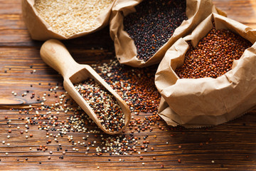 Sticker - Seeds of white, red and black quinoa on the table