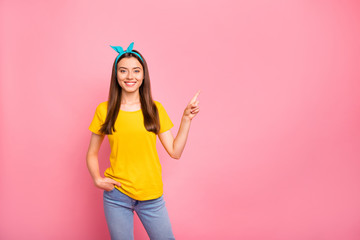 Photo of attractive nice advertising woman wearing jeans denim who would like to point at your best choice advert while isolated with vivid background wearing blue pinup headband