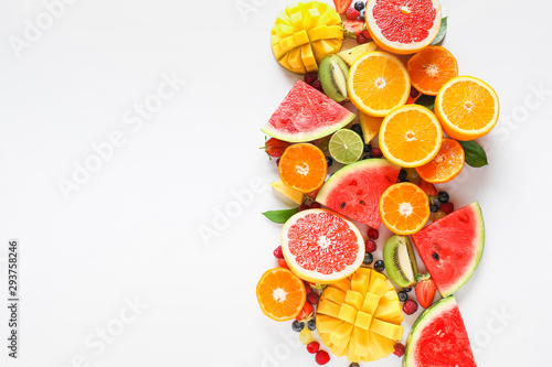 Fotografía Sweet ripe fruits and berries on white background