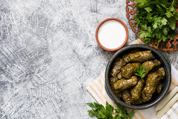 Traditional dolma  (sarma) in grape leaves with copyspace. Lebanon turkish greek middle eastern cuisine. Dinner food dolmadakia