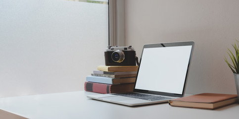 Wall Mural - Open blank screen laptop computer with coffee cup and office supplies in comfortable workplace