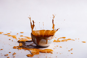 Brown paint splash and cup abstract background