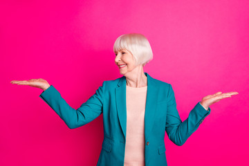 Poster - Portrait of her she nice-looking attractive cheerful cheery gray-haired lady holding invisible objects on palms sale discount isolated over bright vivid shine vibrant pink fuchsia color background