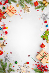 Wall Mural - christmas background with gift boxes, festive decor, fir tree branches and paper cards notes. flat l