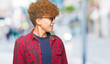 © Krakenimages.com - Young handsome man with afro hair wearing sunglasses looking away to side with smile on face, natural expression. Laughing confident.