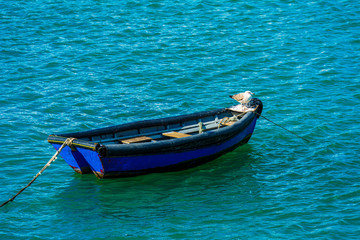 Canvas Print - Fishing boat floating on peaceful sea at Cascais, Portugal